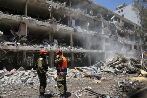 Israeli forces at the site of an Iranian missile strike in Tel Aviv