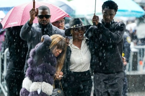 King Combs (R), son of Sean Combs, holds an umbrella for Janice Combs, mother of Sean Combs, as they arrive at federal court for Sean "Diddy" Combs' criminal trial in New York City