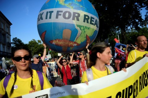 Hundreds of protesters demanded changes to global debt and tax norms in Seville on Sunday