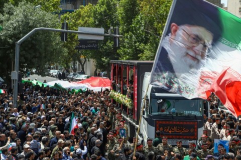 This picture obtained from Iran's ISNA news agency shows a funeral procession of 15 people killed in Israeli strikes in the city of Mashhad on Friday