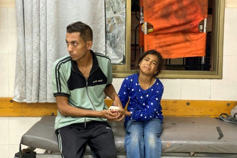 A Palestinian girl treated for wounds sustained in an Israeli strike on a displacement camp in the southern Gaza Strip