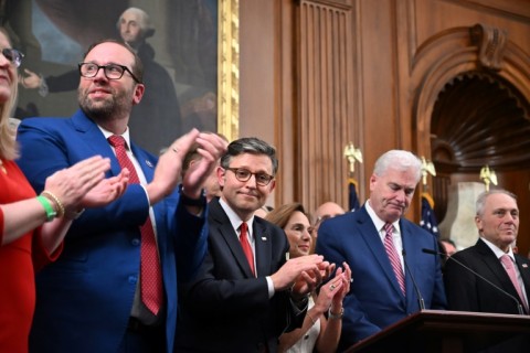 US Speaker of the House Mike Johnson (C) alongside US Republican lawmakers, celebrates the passing of US President Donald Trump's tax bill