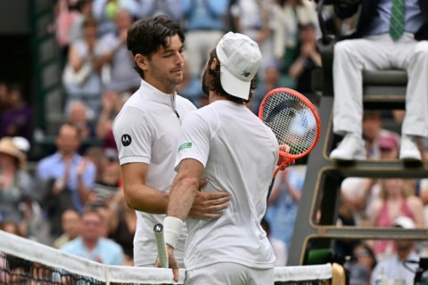 Australia's Jordan Thompson (right) was forced to retire from his Wimbledon fourth-round match against Taylor Fritz with an injury