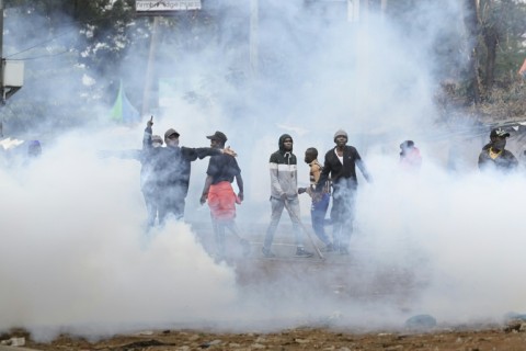 Protesters engulfed in tear gas fired by the police