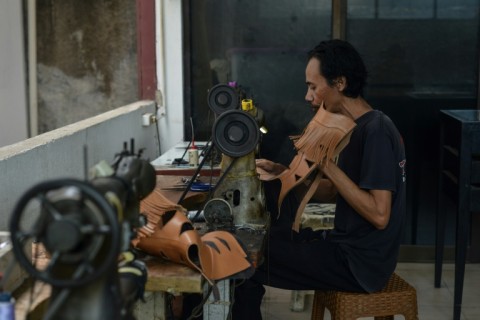 An artisan works on a pair of leather boots at the workshop of Tegep Boots in Bandung, West Java