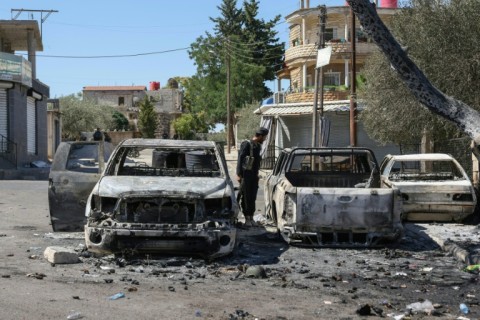 A Syrian government loyalist fires a shoulder-launched weapon in Sweida