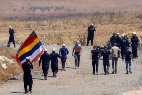 Members of the Druze community from both sides cross the demilitarised zone between Syria and the Israeli-annexed Golan Heights