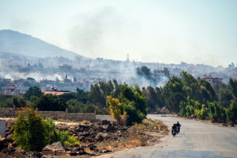Smoke billows over Sweida during deadly clashes on Wednesday putting Druze fighters against Syrian government troops and their allies.