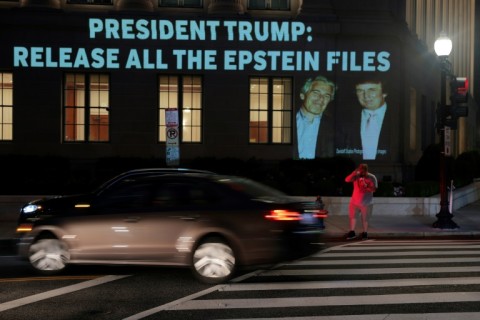 An image of US President Donald Trump and Jeffrey Epstein along with the words 'President Trump: Release All the Epstein Files' is projected on a building in Washington