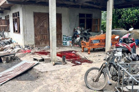 A Royal Thai Army photo taken on July 24, 2025 shows blood stains in front of a damaged house hit by a rocket strike in Surin province's Kap Choeng district