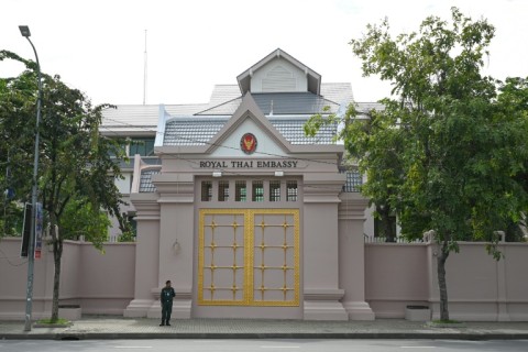 A Cambodian police officer stands guard in front of the Thai embassy in Phnom Penh