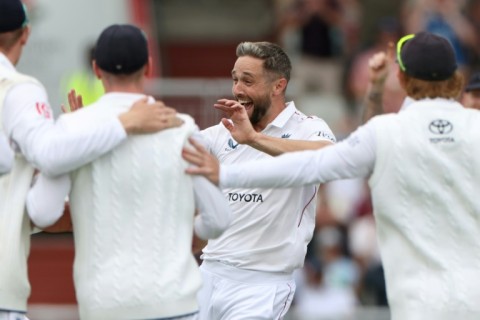 England's Chris Woakes (C) celebrates with team-mates after dismissing Sai Sudharsan in the fourth Test against India at Old Trafford