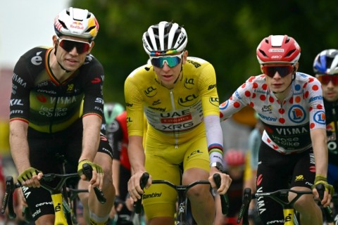Team Visma riders Wout van Aert (L) and Jonas Vingegaard congratulate Tadej Pogacar at the end of stage 20