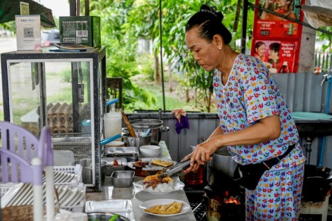 Soeung Chhivling prepares food for customers at her restaurant in Samraong, around 20 kilometres from the border conflict zone