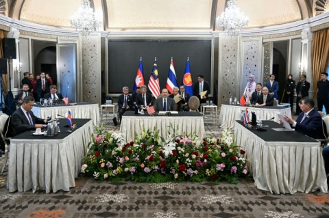 Malaysia's Prime Minister Anwar Ibrahim (centre) looks on as Cambodia's Prime Minister Hun Manet (left) and Thailand's acting Prime Minister Phumtham Wechayachai (right) take part in talks on a possible ceasefire in Putrajaya
