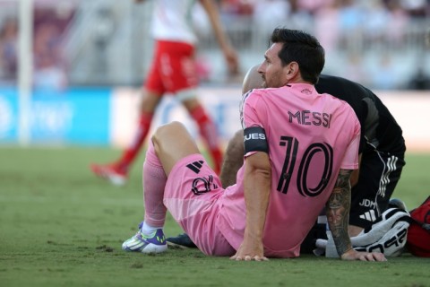 Lionel Messi of Inter Miami is treated by a trainer after suffering an injury early in a Leagues Cup penalty kicks victory over Mexico's Necaxa
