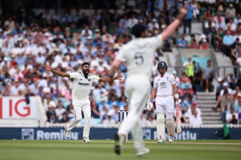 India's Mohammed Siraj (L) celebrates his dismissal of England captain Ollie Pope in the fifth Test at the Oval