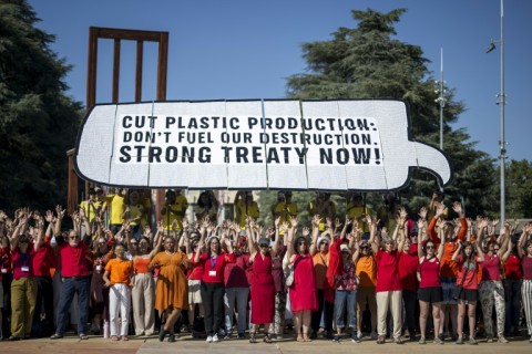 Activists stage a demonstation in front of the UN complext in Geneva ahead of talks on securing a treaty on plastics waste and production