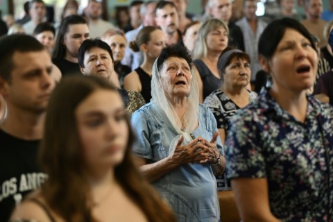 A farewell ceremony for Mykyta and Sofia Lamekhov and their son Lev at a church in Sloviansk