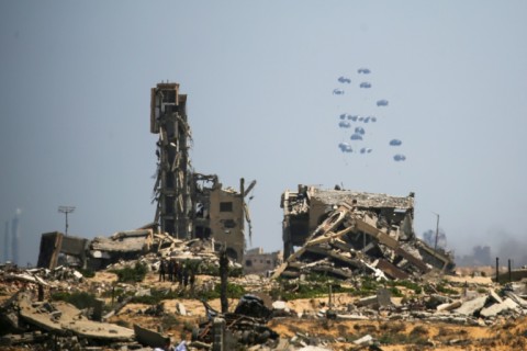 Arab and European militaries airdrop aid over bombed out buildings in central Gaza.