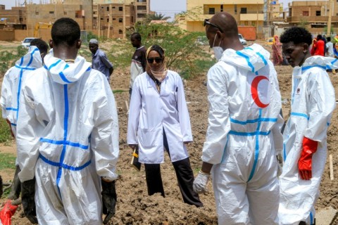 Forensic experts oversee the recovery operation in Khartoum's Al-Azhari neighbourhood, which saw 317 bodies exhumed from a single vacant lot