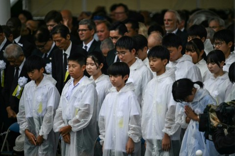 After heavy downpours Saturday morning, the rain stopped shortly before a moment of silence and ceremony