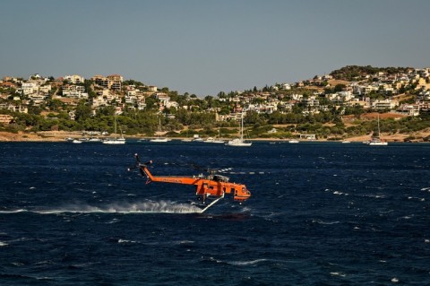 Beachside diners were greeted with the spectacle of water bombers skimming the water to refill and return to the raging fires