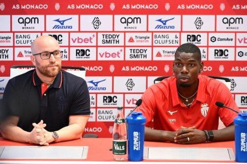Pogba next to Monaco's Brazilian general manager Thiago Scuro (L) during his official presentation at the club