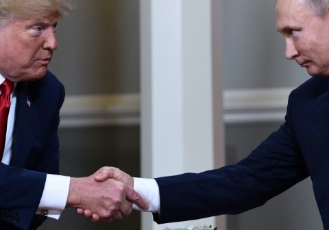 In this file photo taken on July 16, 2018, US President Donald Trump and Russian President Vladimir Putin shake hands ahead a meeting in Helsinki