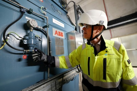 Statkraft's Guy Nicholson stands by a flywheel at the firm's new Greener Grid Park in Liverpool, one of the projects contracted by the city to keep the lights on