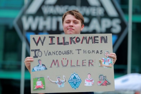 A fan holds a sign welcoming German Thomas Mueller to the Vancouver Whitecaps before his debut with his new Major League Soccer club