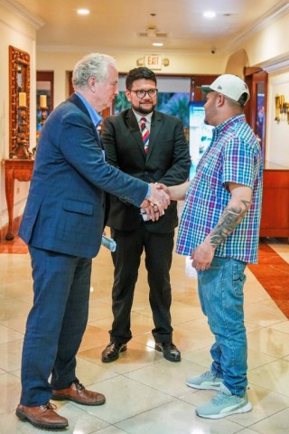 US Senator Chris Van Hollen (L) shakes hands with Salvadoran migrant Kilmar Abrego Garcia (R), a US resident wrongfully deported to his home country, at a hotel in San Salvador