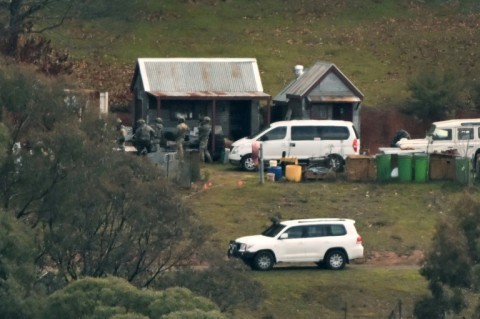 Australian police searched buildings for a gunman suspected of killing two officers