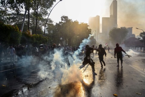 Police fire tear gas to disperse demonstrators during a protest in Surabaya on August 29, 2025