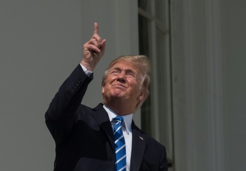 US President Donald Trump looking up -- without the recommended safety glasses -- at a partial solar eclipse in 2017