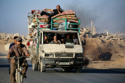 Palestinians flee south on the coastal road in central Gaza last month. Most Gazans have been displaced at least once during the war