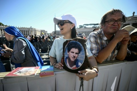A portrait of Acutis is displayed onto the facade of St Peter's Basilica