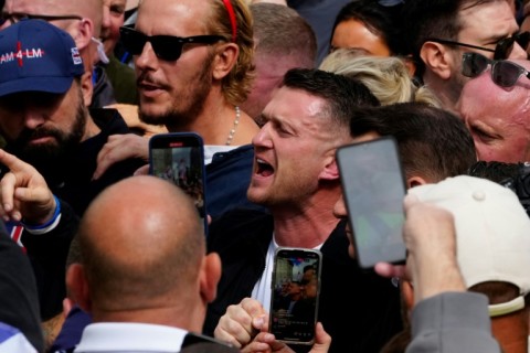 British far-right activist Tommy Robinson (C), called for Saturday's march and rally