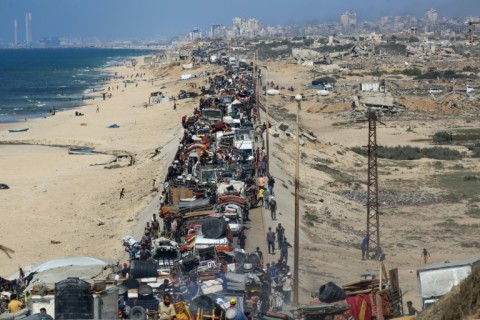 Palestinians move with their belongings southwards on a road in the Nuseirat refugee camp area in the central Gaza Strip following renewed Israeli evacuation calls for Gaza City on September 14, 2025