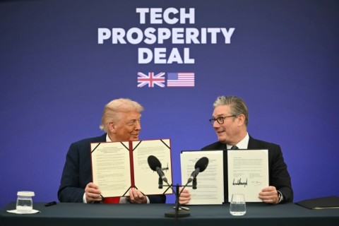 Britain's Prime Minister Keir Starmer (R) and US President Donald Trump (L) show off their signed technology deal at a business event at Chequers