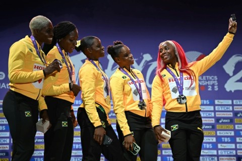 Leader of the pack: Shelly-Ann Fraser-Pryce takes one last picture with her sprint relay teammates
