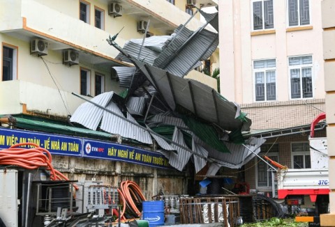 Images published by AFP showed corrugated metal roofs blown off buildings and household debris strewn across saturated streets in coastal Nghe An province