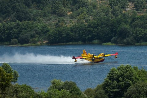Canadair firefighting planes scoop up water to fight wildfires, as seen here in a 2025 firefight in Portugal