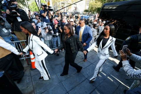 Chance Combs (C) walks with twin sisters Jessie James Combs and and D'Lila Star Combs as they arrive at Manhattan Federal Court for the sentencing of Sean "Diddy" Combs