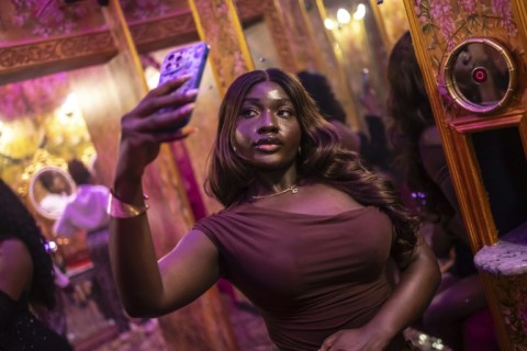 A woman takes a selfie in the restroom of Zaza in Lagos