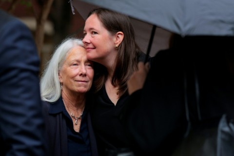 Patrice Failor (L), the wife of James Comey, is embraced by their daughter Maurene as they arrive at a federal courthouse in Virginia for the arraignment of the former FBI director