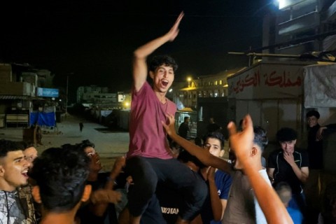 Men celebrated in southern Gaza's Khan Yunis after the deal was announced