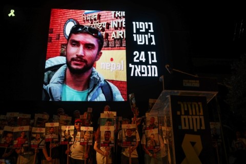 A picture of Nepalese national Bipin Joshi held hostage by Palestinian militants in Gaza since 2023, is displayed on a screen during a demonstration organised by the families of hostages calling for action to secure their release in Tel Aviv on August 16, 2025