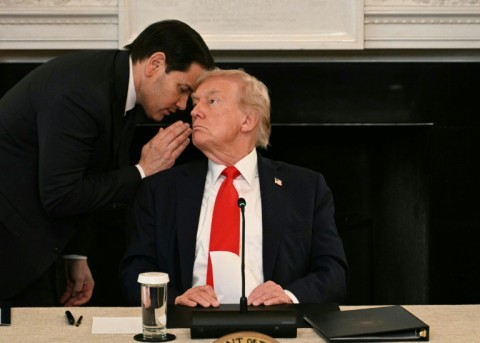 US Secretary of State Marco Rubio whispers in the ear of President Donald Trump during a roundtable about Antifa in the State Dining Room of the White House