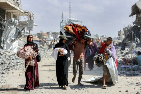 People carried children and belongings as they made their way through the rubble of destroyed buildings to return home